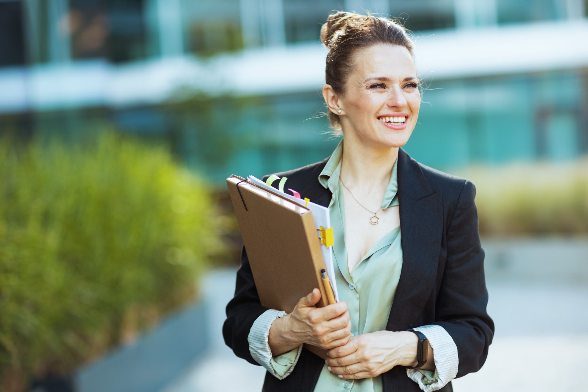 happy modern business woman near office building happy modern business woman near office building
